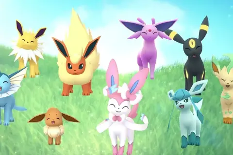 Wesołe nowe ewolucje Eevee: Vaporeon, Jolteon, Flareon, Espeon, Umbreon, Leafeon, Glaceon i Sylveon na trawiastym tle.