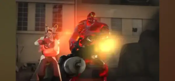 Medic TF2 z bronią, obok niego potężny Heavy w czerwonym stroju, obaj w ogniu walki.